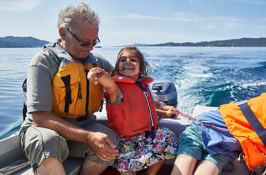Grandfather and grandchildren on boat ride