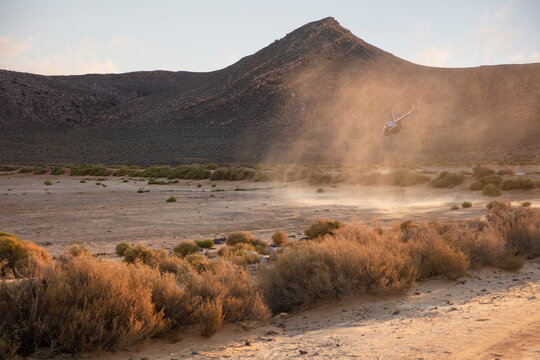 Helicopter landing in dusty rural landscape, Cape Town, Western Cape, South Africa