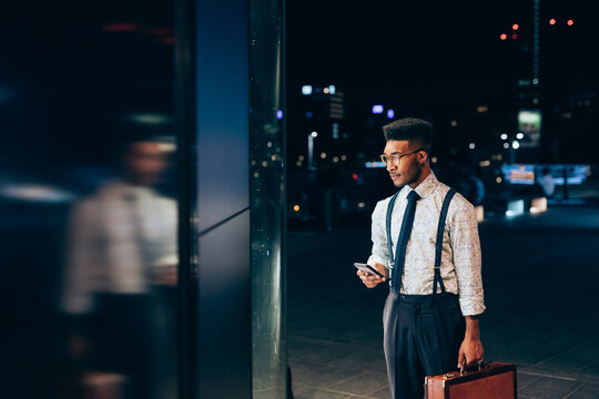 Businessman looking into window of shop