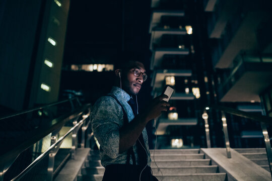 Businessman using smartphone on stairs of office building