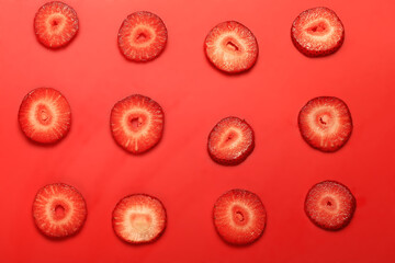 pattern of cut strawberries on a red background