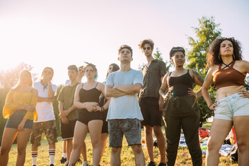 Group of friends posing under hot sun in park