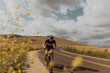 Young female cyclist cycling on rural road, Exeter, California, USA