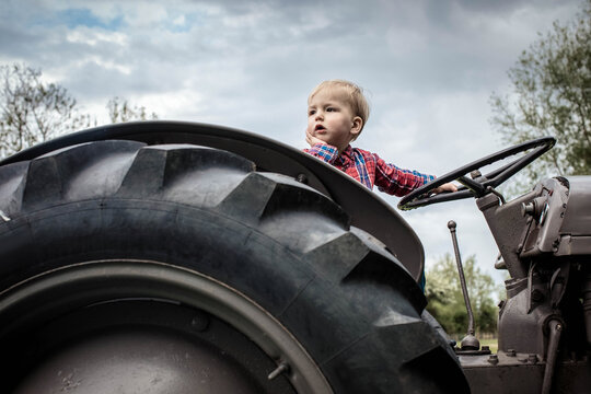 Toddler in deep thought on tractor