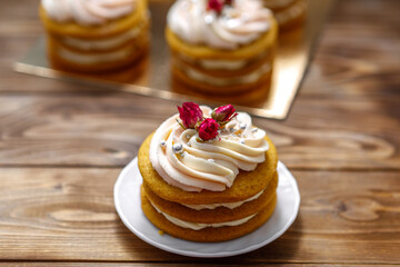 Sponge cake with cream, decorated with small flowers.