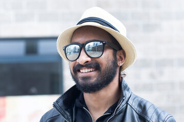 Portrait of smiling man with hat and sunglasses