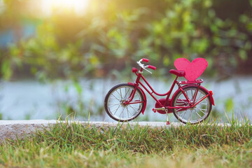 Fototapeta na wymiar Red bicycle vintage in spring nature summer background copy spec, Red heart on bicycle