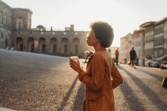 Young woman with afro hair exploring city, Florence, Toscana, Italy