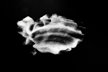 White soapy foam texture. Shampoo foam with bubbles.White facial foam creamy bubble soap sponge isolated on black background.