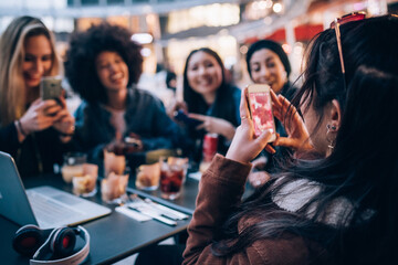Friends having drinks at outdoor cafe, Milan, Italy