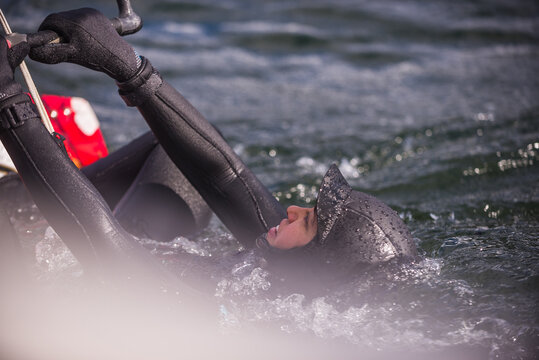 Woman kite surfing in sea