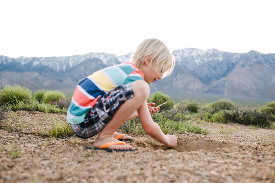 Boy exploring rural landscape, Olancha, California, US