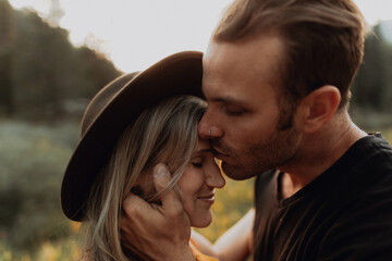 Romantic mid adult man kissing girlfriend on forehead in rural valley, portrait, Mineral King, California, USA
