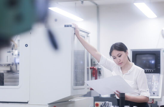 Asian woman reading and working in technical office