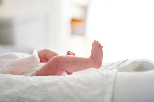 Baby lying down on U-shaped pillow at home
