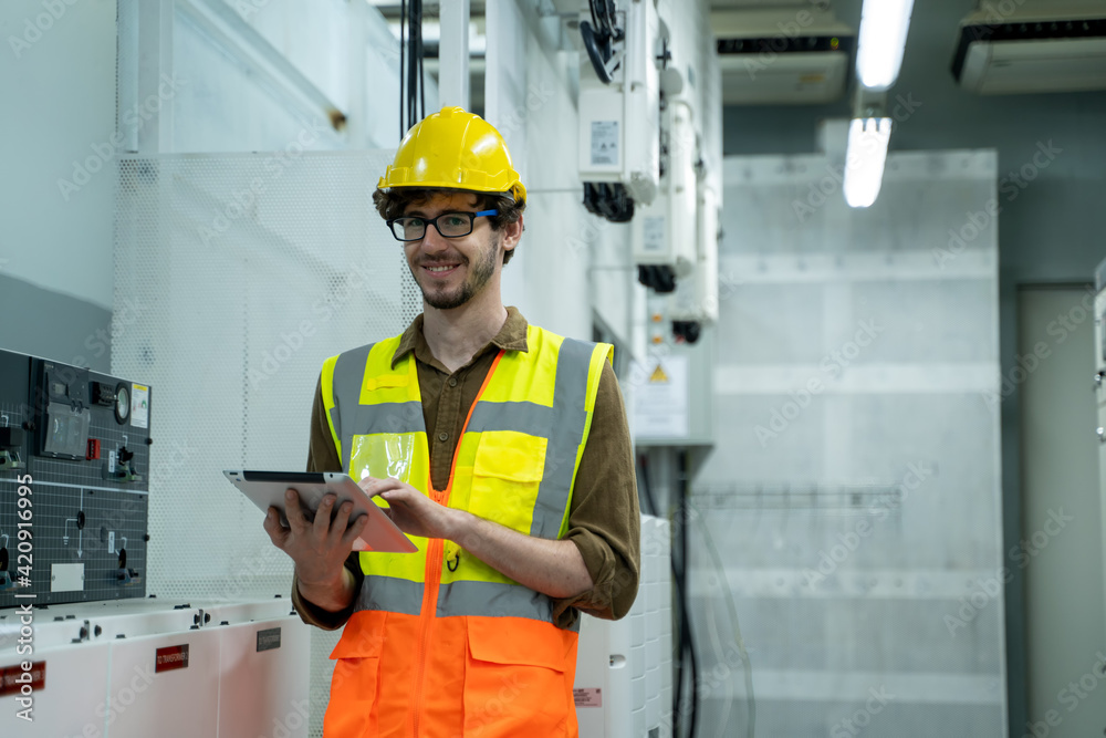 Aufkleber electrical engineers use digital tablet checking in power plant control room at large industry facto