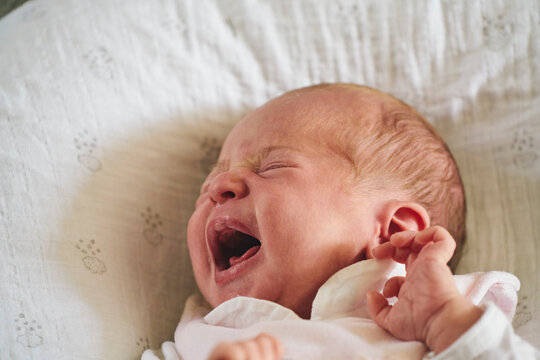Baby crying on U-shaped pillow
