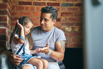 Daughter sitting on father's lap