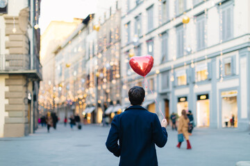 Man with heart shaped balloon at piazza, Firenze, Toscana, Italy