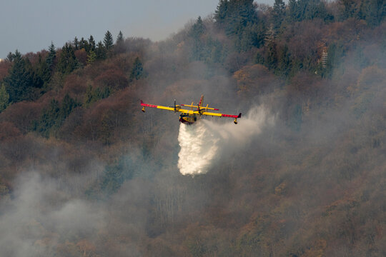 Canadair Throwing Water To Extinguish Fire On Sacro Monte, Varese, Italy