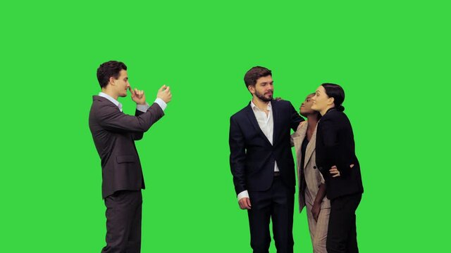 Young attractive smiling office workers posing for a picture on a Green Screen, Chroma Key.