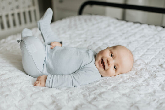Baby boy smiling in bed