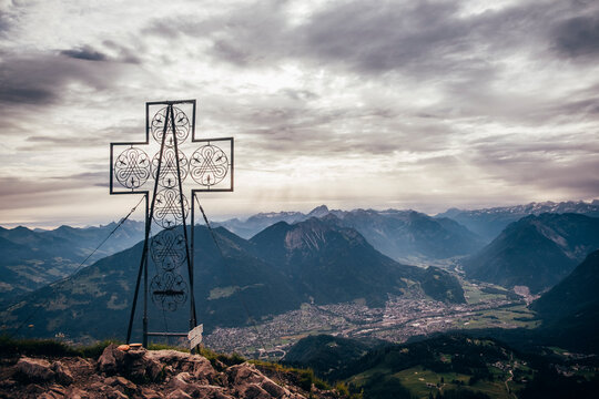 Large cross structure on peak, mountain ranges in background, Bludenz, Vorarlberg, Austria