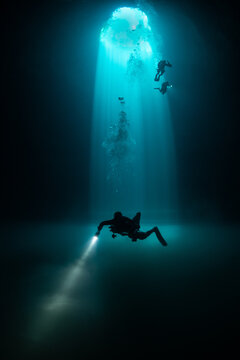 Divers exploring Cenote Maravilla, Mexico