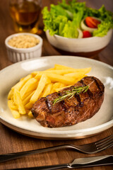 Grilled steak with french fries, brazilian farofa and salad.