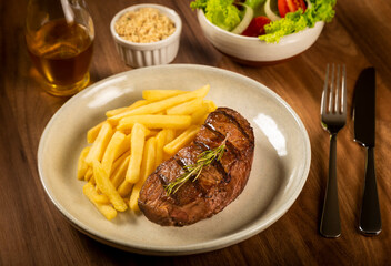 Grilled steak with french fries, brazilian farofa and salad.