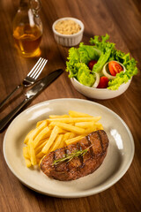 Grilled steak with french fries, brazilian farofa and salad.