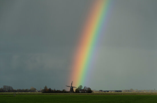 Rainbow over historic windmill, Wyns, Friesland, Netherlands