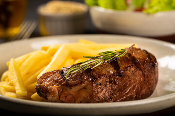 Grilled steak with french fries, brazilian farofa and salad.