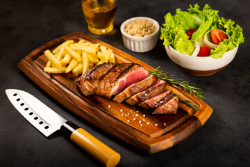 Grilled steak with french fries, brazilian farofa and salad.