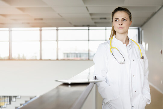 Doctor taking break at corridor in hospital