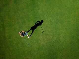 Woman playing golf on golf course