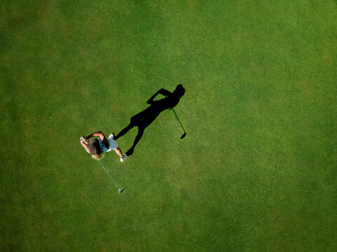 Woman playing golf on golf course
