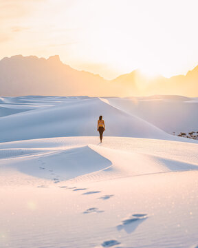  Woman on white sand dunes, White Sands National Monument, New Mexico, US