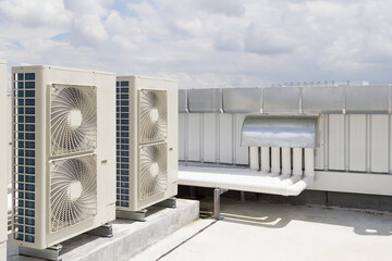 Condenser unit or compressor on roof of industrial plant building with sky background. Unit of...