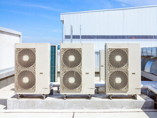Condenser unit or compressor on roof of industrial plant building with sky background. Unit of...