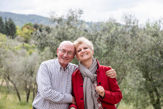 Portrait of senior couple, olive trees in background, Florence, Italy - Powered by Adobe