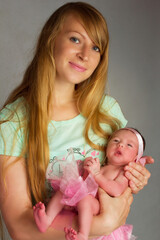 photo of a baby girl in a pink skirt and bow.