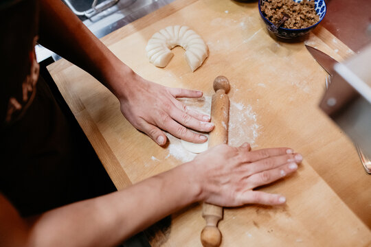 High angle close up of chef preparing a gyoza in a Ramen and Gyoza restaurant in Italy.