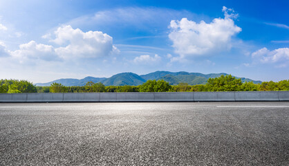country road and green mountains in summer.