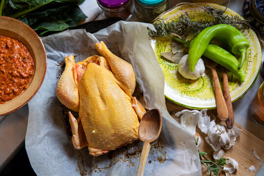 High angle close up of free range chicken, peppers, garlic and herbs.