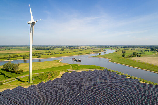 Solar panels and wind turbine near Ijssel river, The Netherlands.