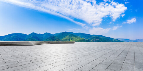Wide city square and green mountain in summer. © ABCDstock