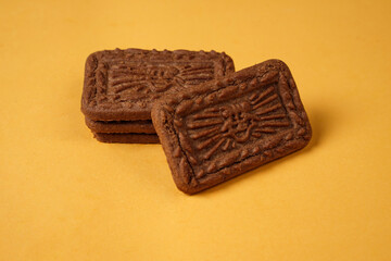 Square-shaped chocolate biscuits are suitable as a side snack to the breakfast menu. Start the morning with biscuits. Can be consumed by all ages from toddlers to the elderly. Stack of biscuits.