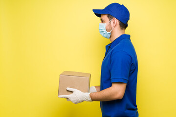 Man with a face mask working as a delivery courier