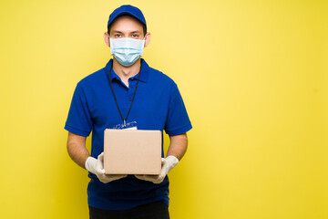 Cheeful hispanic worker standing in a bright background